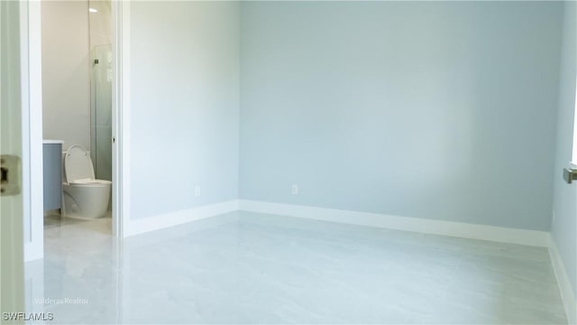 empty room featuring baseboards