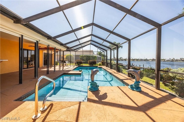 pool featuring a water view, a patio area, and glass enclosure