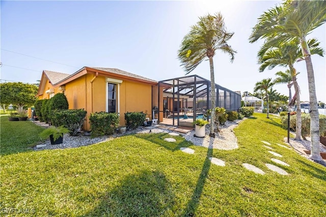 view of yard featuring an outdoor pool and a lanai