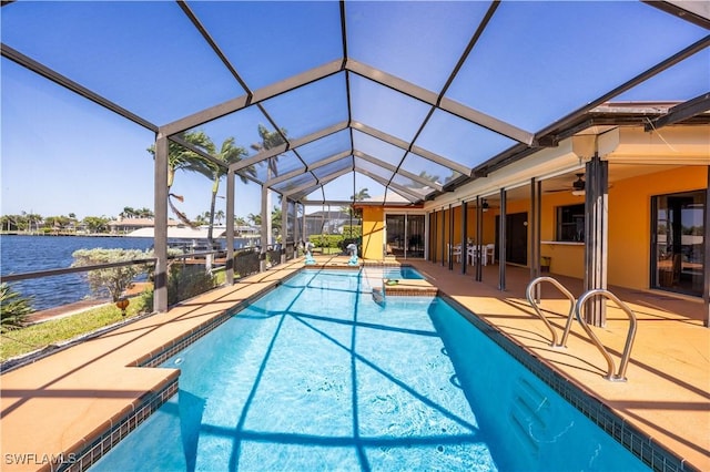 pool with a water view, a patio area, and a lanai