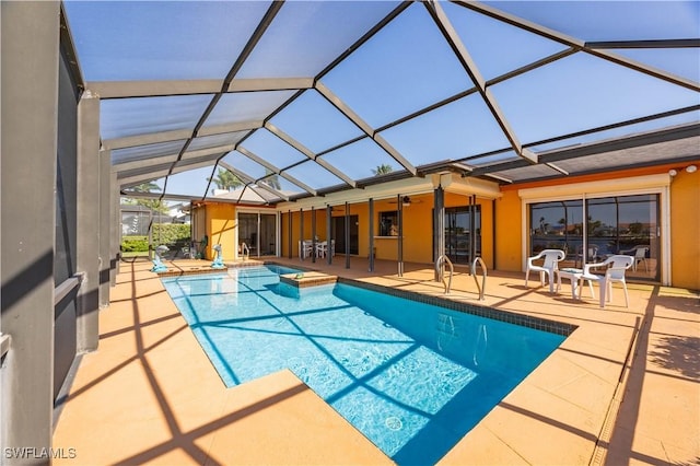 pool featuring a lanai, a patio area, and a hot tub