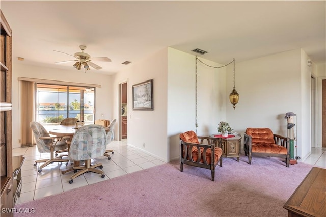 dining area with light colored carpet, a ceiling fan, visible vents, and light tile patterned floors