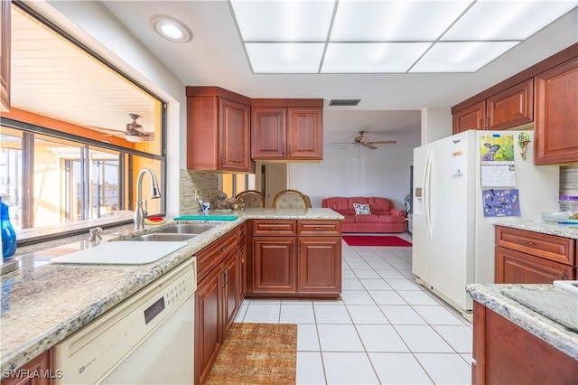 kitchen featuring white appliances, a ceiling fan, visible vents, light tile patterned flooring, and a sink
