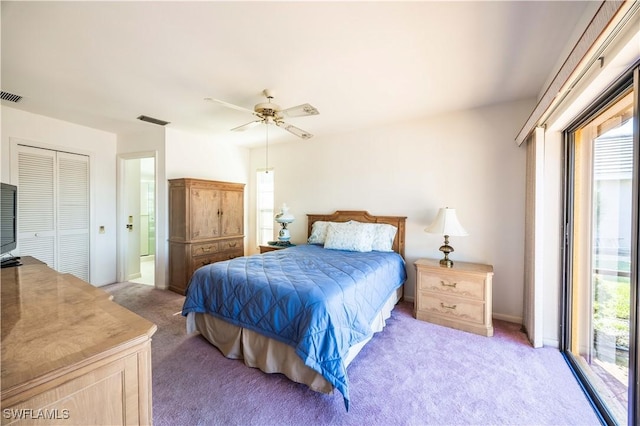 bedroom with a closet, light colored carpet, a ceiling fan, and visible vents