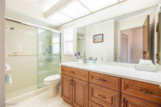 bathroom with toilet, a stall shower, and vanity