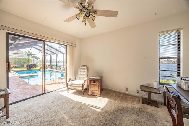 living area with a swimming pool, ceiling fan, a sunroom, carpet flooring, and baseboards