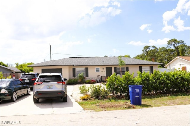 18254 Lowe Dr, Fort Myers, FL 33967 - single story home featuring a shingled roof, driveway, stucco siding, and an attached garage