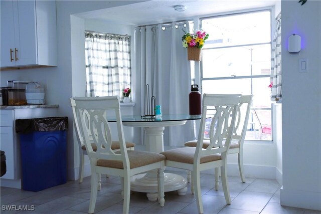 18254 Lowe Dr, Fort Myers, FL 33967 - dining area featuring light tile patterned floors and a healthy amount of sunlight