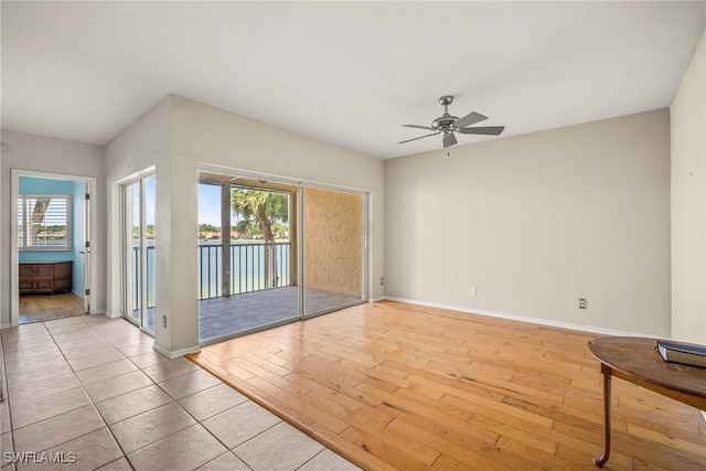 2651 Citrus Lake Dr Unit D203, Naples, FL 34109 - unfurnished room featuring baseboards, a ceiling fan, and hardwood / wood-style floors