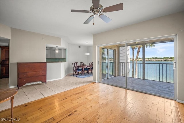 2651 Citrus Lake Dr Unit D203, Naples, FL 34109 - spare room featuring hardwood / wood-style flooring, baseboards, a ceiling fan, and a water view