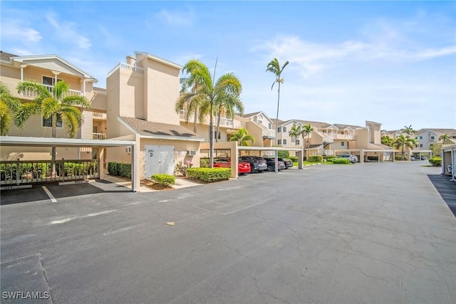 2651 Citrus Lake Dr Unit D203, Naples, FL 34109 - covered parking lot featuring a residential view