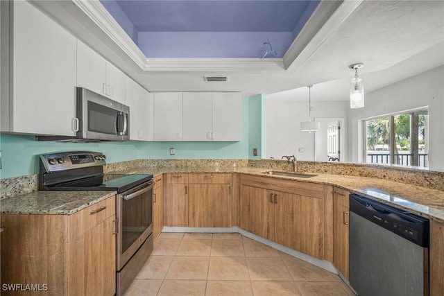 2651 Citrus Lake Dr Unit D203, Naples, FL 34109 - kitchen featuring light stone countertops, a tray ceiling, a sink, and appliances with stainless steel finishes
