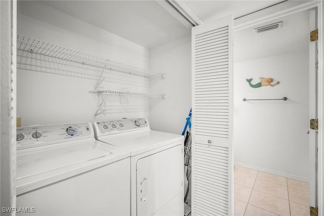 2651 Citrus Lake Dr Unit D203, Naples, FL 34109 - washroom with separate washer and dryer, light tile patterned floors, visible vents, baseboards, and laundry area