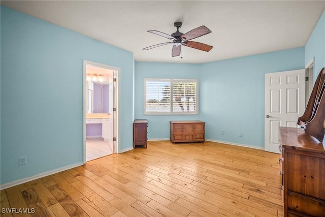 2651 Citrus Lake Dr Unit D203, Naples, FL 34109 - unfurnished bedroom featuring wood-type flooring, baseboards, ceiling fan, and connected bathroom