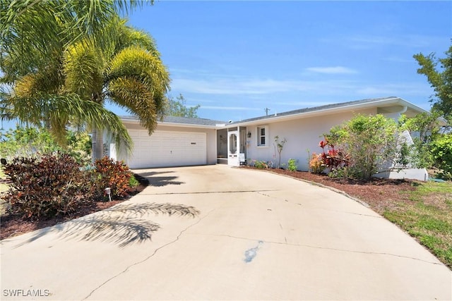 1514 Canal St, Lehigh Acres, FL 33936 - ranch-style house featuring a garage, driveway, and stucco siding