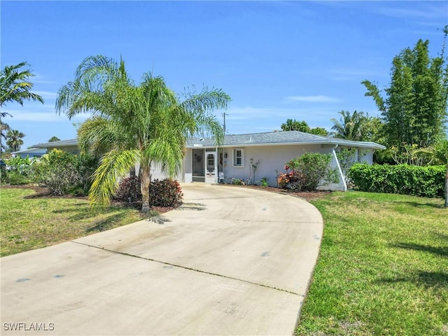 1514 Canal St, Lehigh Acres, FL 33936 - single story home featuring stucco siding, a front lawn, and concrete driveway