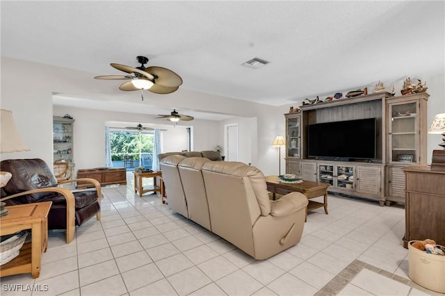 1514 Canal St, Lehigh Acres, FL 33936 - living area featuring light tile patterned flooring, visible vents, and a ceiling fan