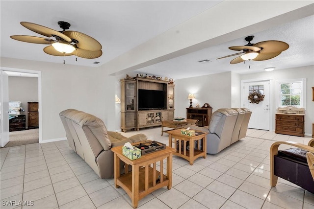 1514 Canal St, Lehigh Acres, FL 33936 - living room with a ceiling fan, light tile patterned flooring, and visible vents