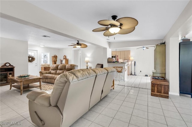1514 Canal St, Lehigh Acres, FL 33936 - living room featuring visible vents, baseboards, ceiling fan, and light tile patterned floors