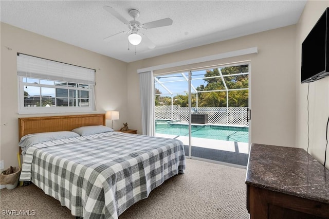 1514 Canal St, Lehigh Acres, FL 33936 - carpeted bedroom featuring a textured ceiling, ceiling fan, and access to exterior