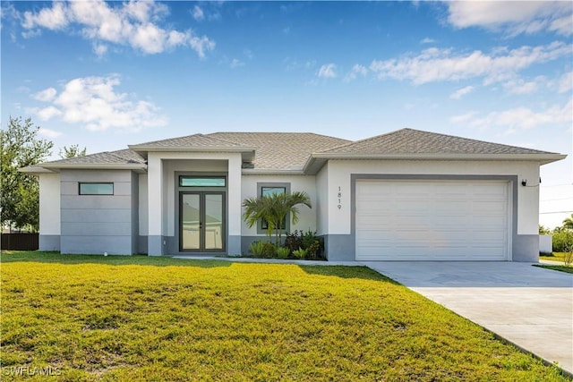 1819 NW 19th Ave, Cape Coral, FL 33993 - prairie-style home with stucco siding, a front lawn, driveway, and an attached garage