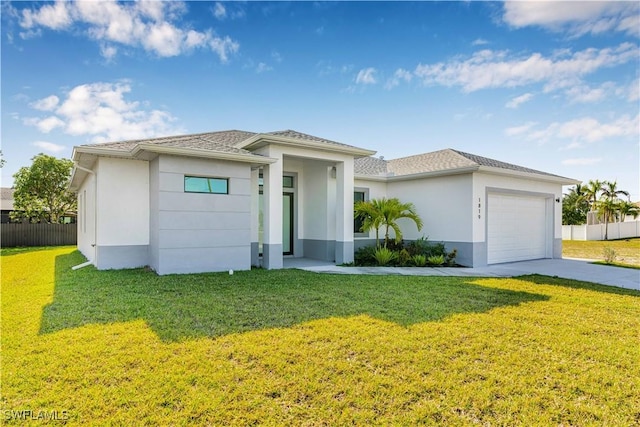 1819 NW 19th Ave, Cape Coral, FL 33993 - prairie-style home with stucco siding, fence, a garage, driveway, and a front lawn