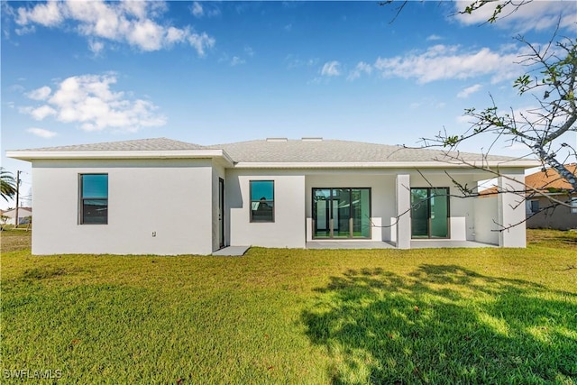 1819 NW 19th Ave, Cape Coral, FL 33993 - rear view of property with a lawn, stucco siding, and a patio area
