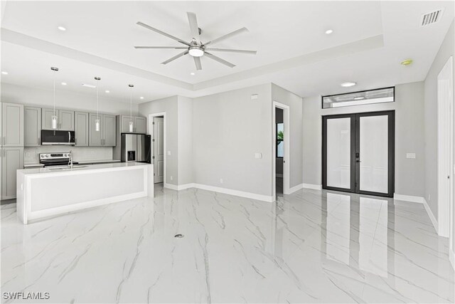 1819 NW 19th Ave, Cape Coral, FL 33993 - unfurnished living room with recessed lighting, marble finish floor, and baseboards