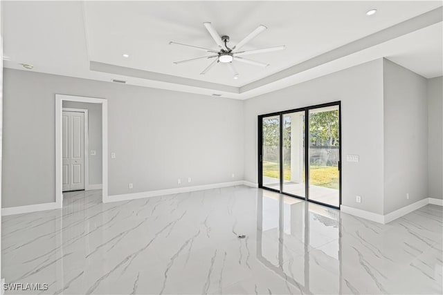 1819 NW 19th Ave, Cape Coral, FL 33993 - spare room with marble finish floor, baseboards, visible vents, a raised ceiling, and a ceiling fan