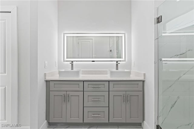 1819 NW 19th Ave, Cape Coral, FL 33993 - bathroom with a marble finish shower, double vanity, a sink, and baseboards