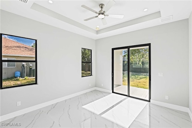 1819 NW 19th Ave, Cape Coral, FL 33993 - empty room with recessed lighting, marble finish floor, baseboards, and a tray ceiling