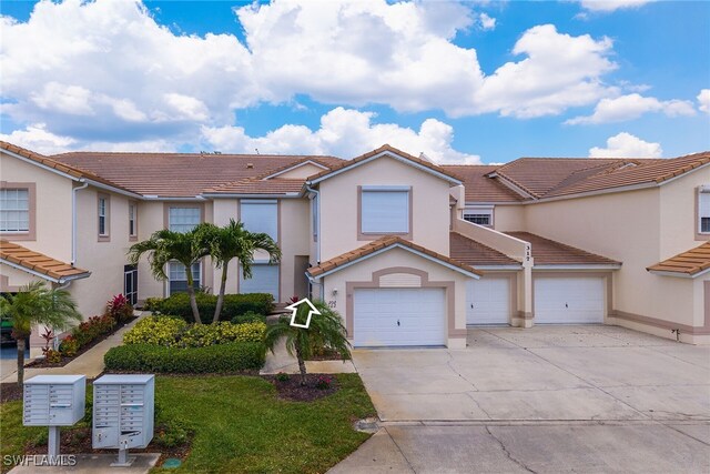 317 Sunrise Cay Unit 1-102, Naples, FL 34114 - view of front facade with concrete driveway, stucco siding, a tiled roof, and a garage