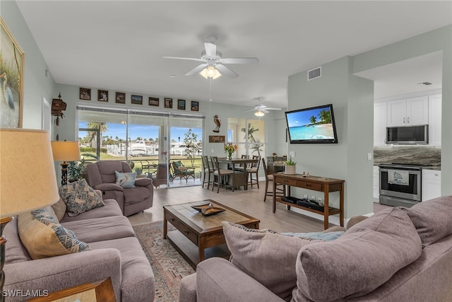 317 Sunrise Cay Unit 1-102, Naples, FL 34114 - living room with light wood-type flooring, ceiling fan, and visible vents