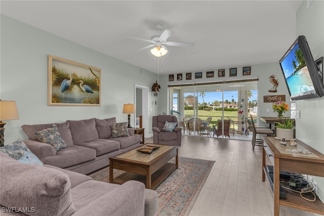 317 Sunrise Cay Unit 1-102, Naples, FL 34114 - living area featuring wood finished floors and a ceiling fan