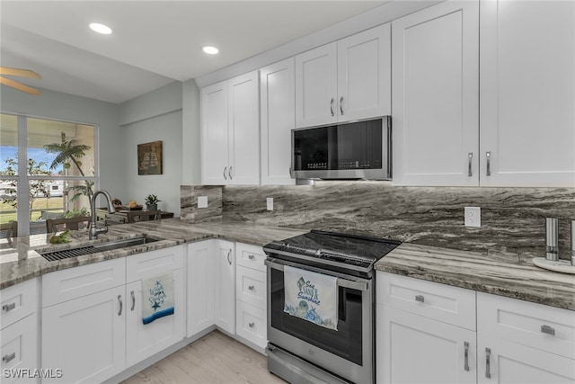 317 Sunrise Cay Unit 1-102, Naples, FL 34114 - kitchen featuring stone countertops, recessed lighting, white cabinets, appliances with stainless steel finishes, and a sink