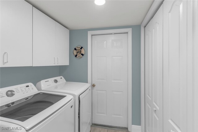 317 Sunrise Cay Unit 1-102, Naples, FL 34114 - washroom with cabinet space and washing machine and dryer