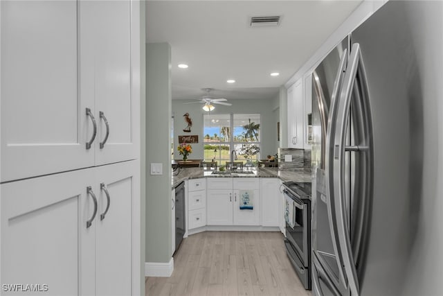 317 Sunrise Cay Unit 1-102, Naples, FL 34114 - kitchen featuring white cabinets, recessed lighting, visible vents, and appliances with stainless steel finishes