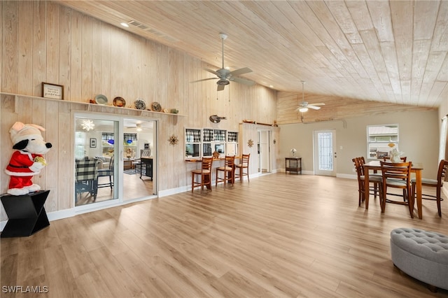 living area featuring high vaulted ceiling, wood ceiling, a ceiling fan, and wood finished floors