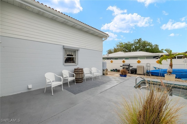view of patio featuring grilling area and fence