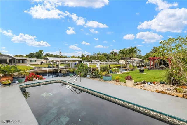 view of swimming pool with a water view, boat lift, a lawn, and a dock
