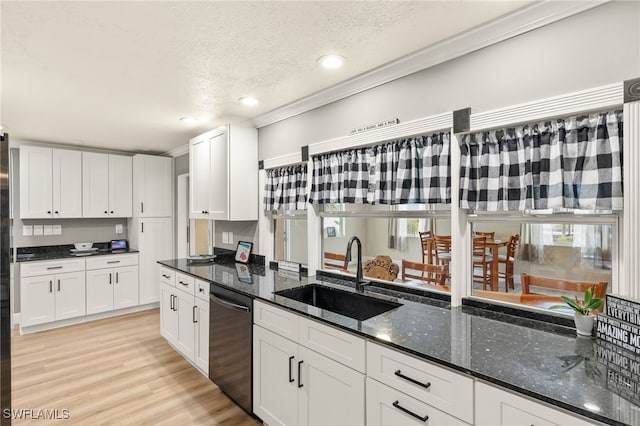 kitchen with recessed lighting, a textured ceiling, white cabinets, stainless steel dishwasher, and a sink