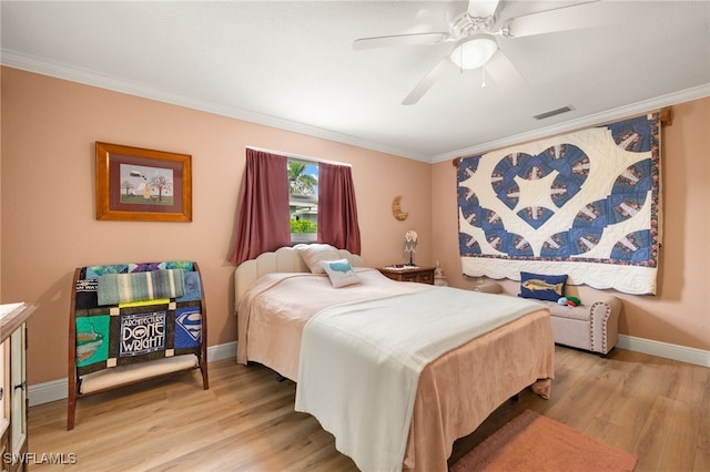 bedroom with visible vents, baseboards, ceiling fan, crown molding, and light wood finished floors