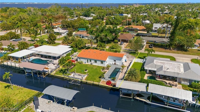 birds eye view of property with a water view and a residential view