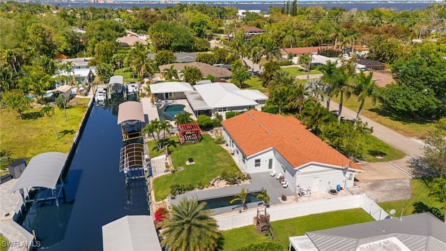 drone / aerial view featuring a water view and a residential view