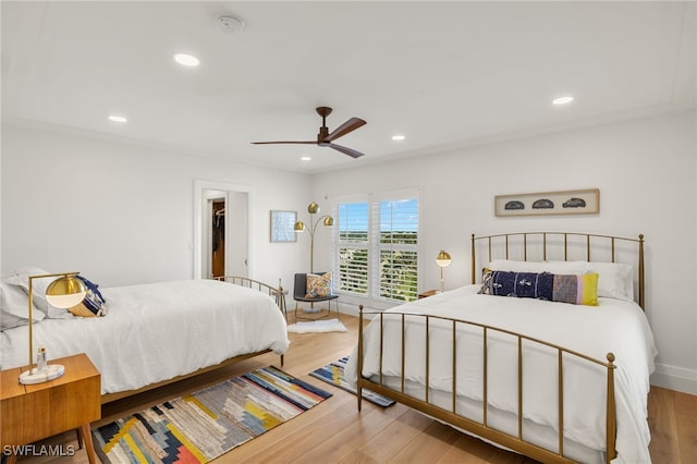 bedroom with ceiling fan, recessed lighting, and wood finished floors