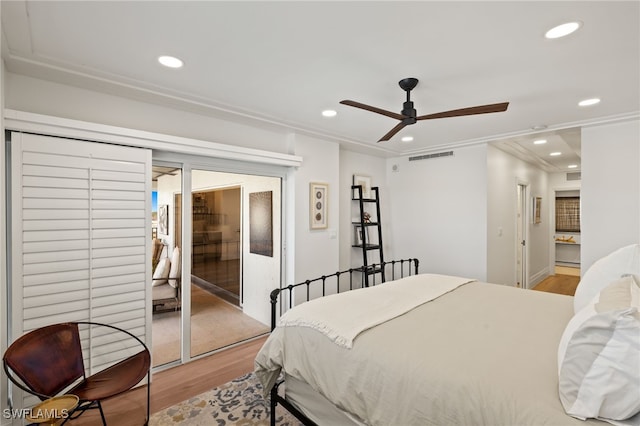 bedroom featuring recessed lighting, light wood-style flooring, visible vents, and ornamental molding