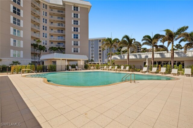 pool featuring a patio and fence