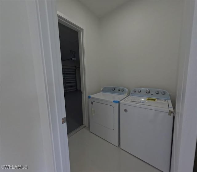 washroom with separate washer and dryer and laundry area