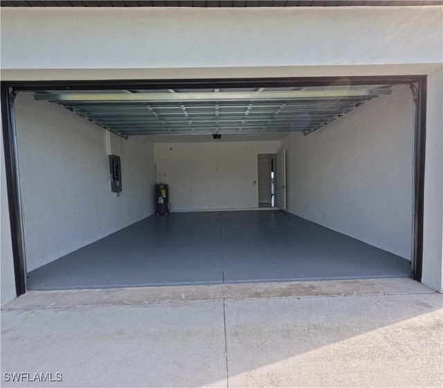 garage with electric water heater and electric panel