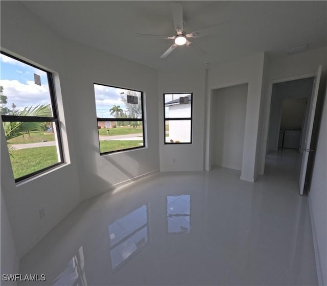 unfurnished room with washer / clothes dryer, tile patterned floors, and ceiling fan